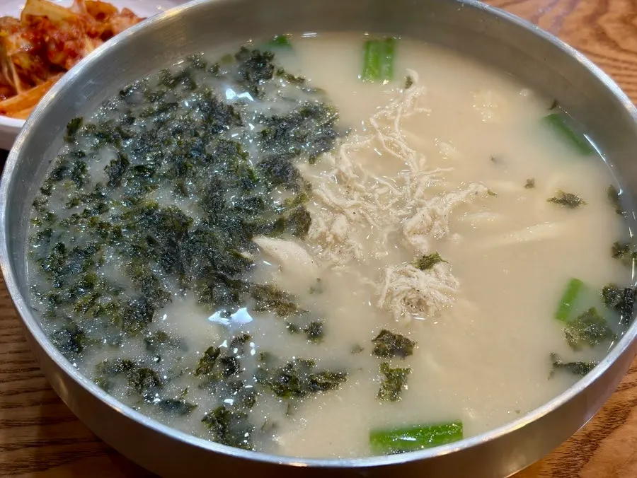 Close-up of the milky dak kalguksu broth