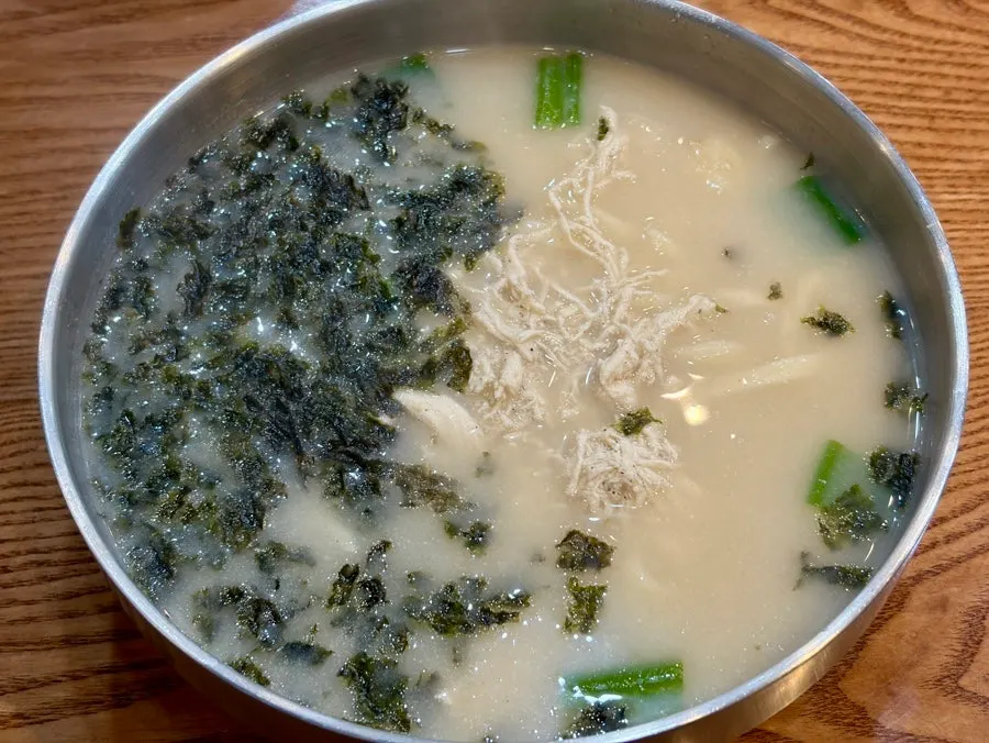 A spoonful of the rich chicken broth