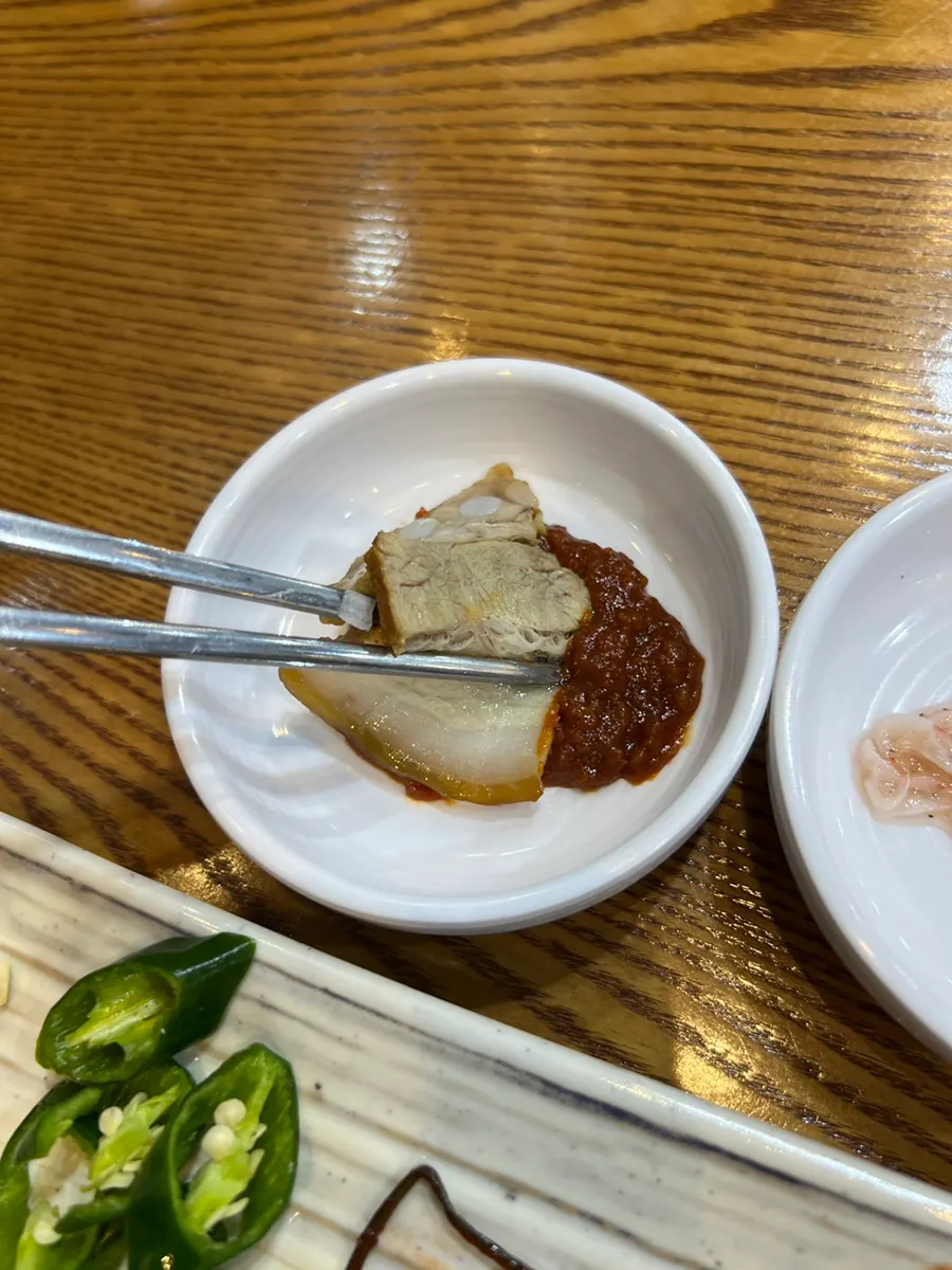 수육에 매운김치 올린 한 입