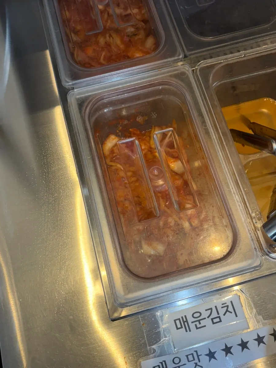 Side dish station with spicy and mild kimchi kept separate