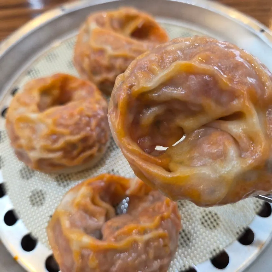 Kimchi mandu served in a steamer basket