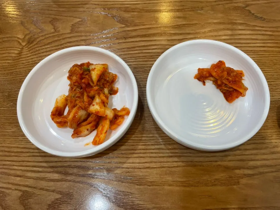 A plate of spicy kimchi and side dishes brought to the table