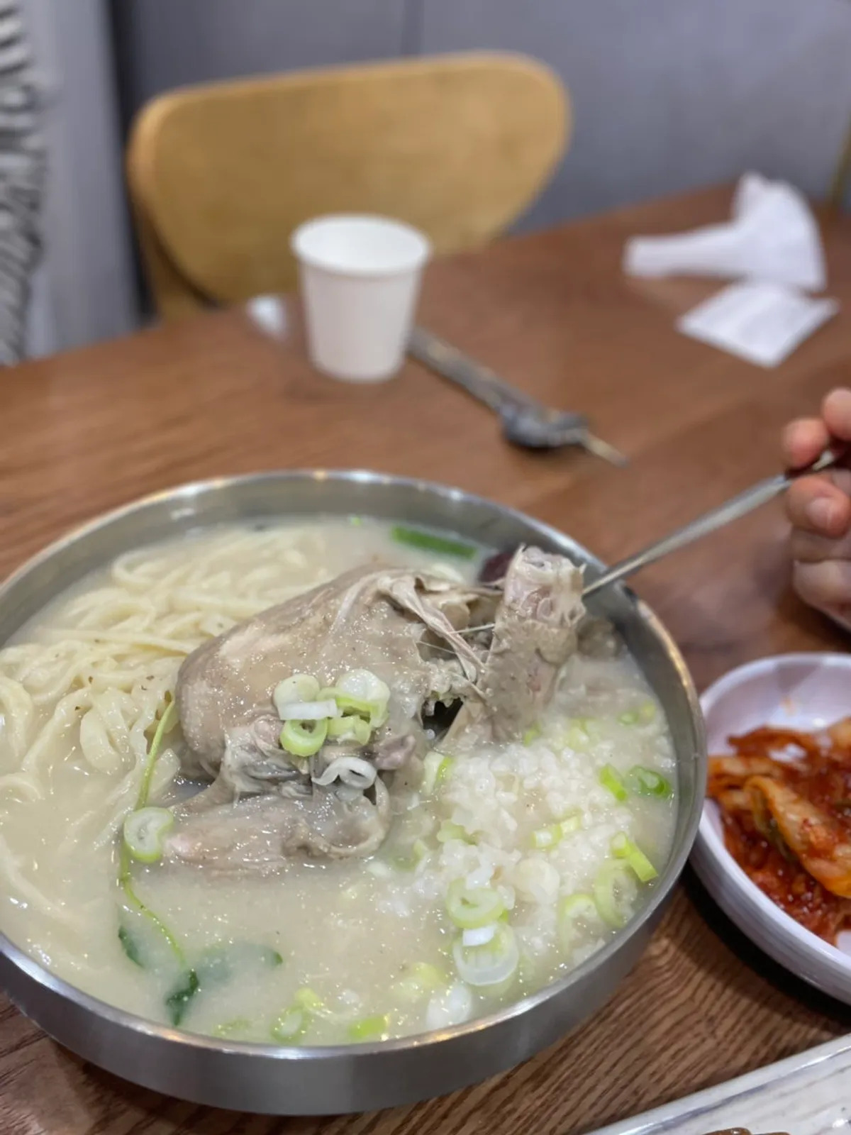 Tender chicken leg falling apart in samgyetang kalguksu