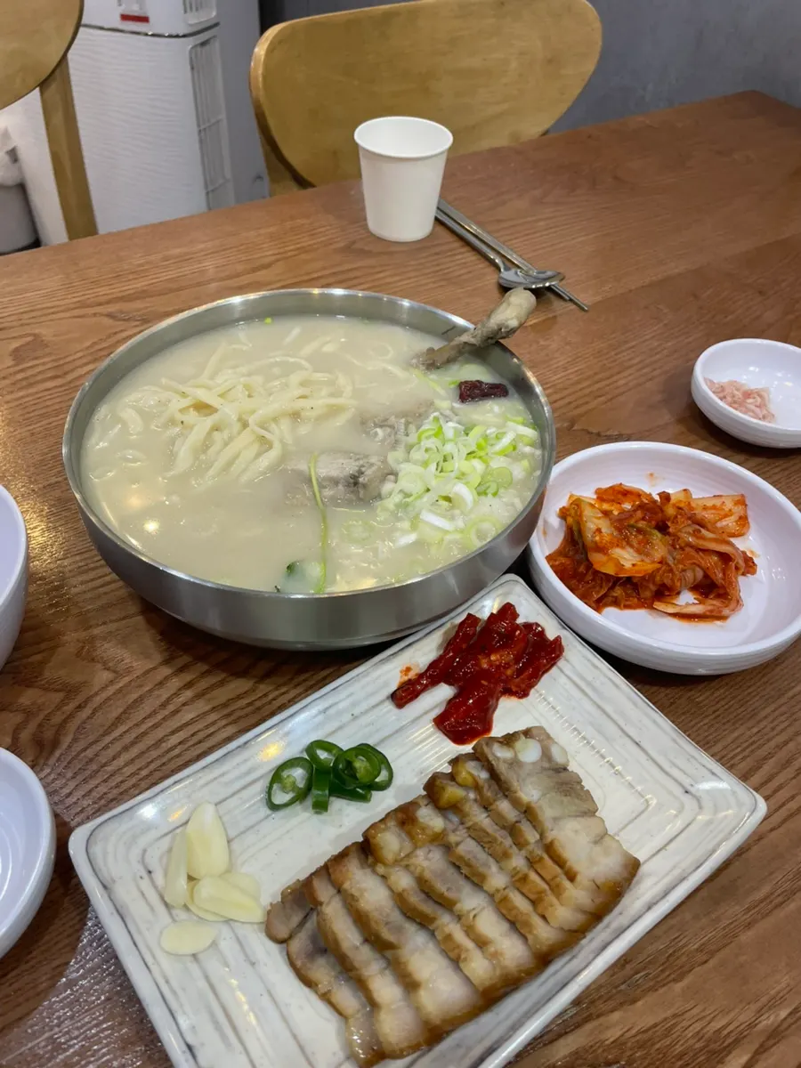 House-made kalguksu noodles lifted from the bowl