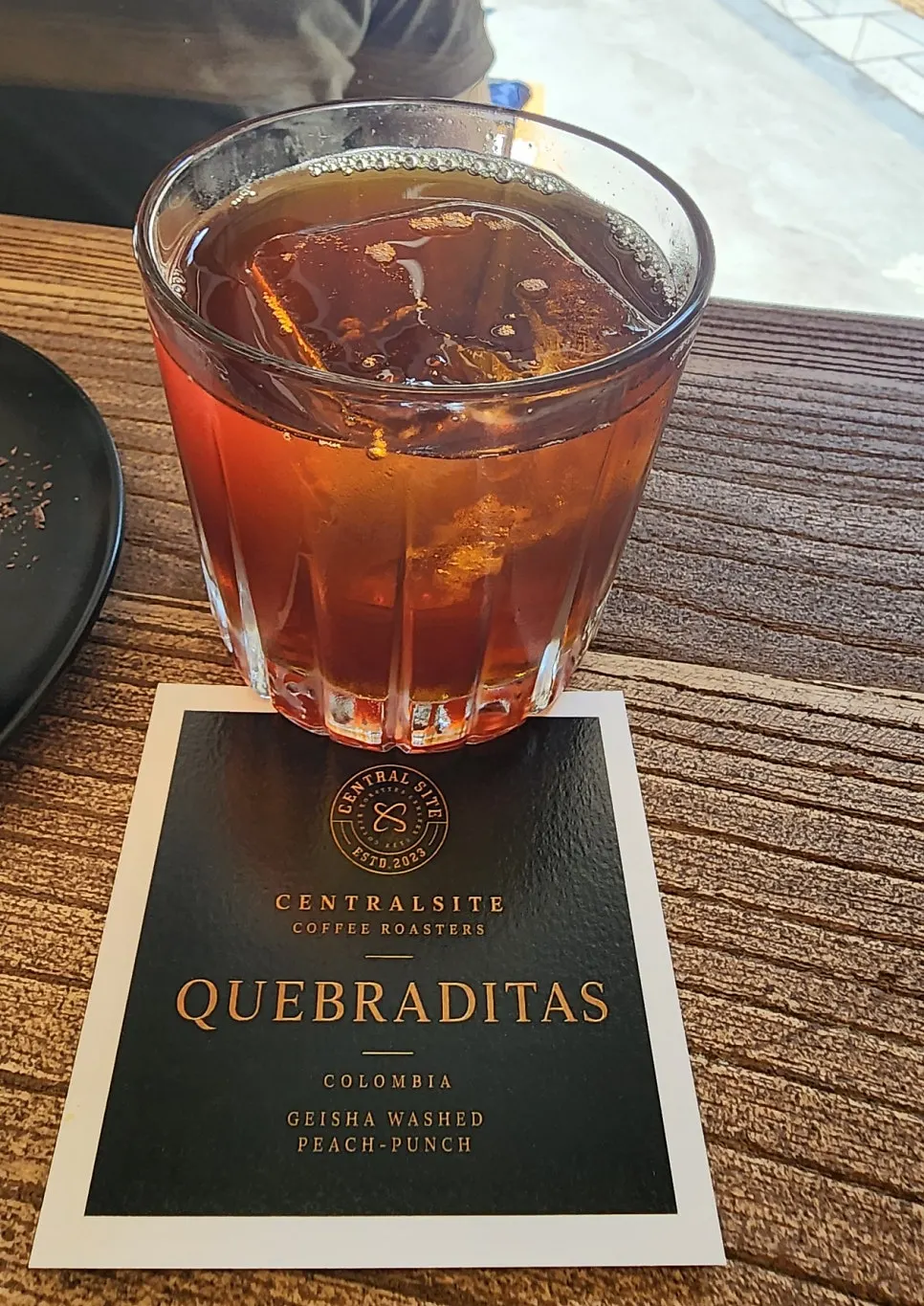 Coffee served with a bean information card