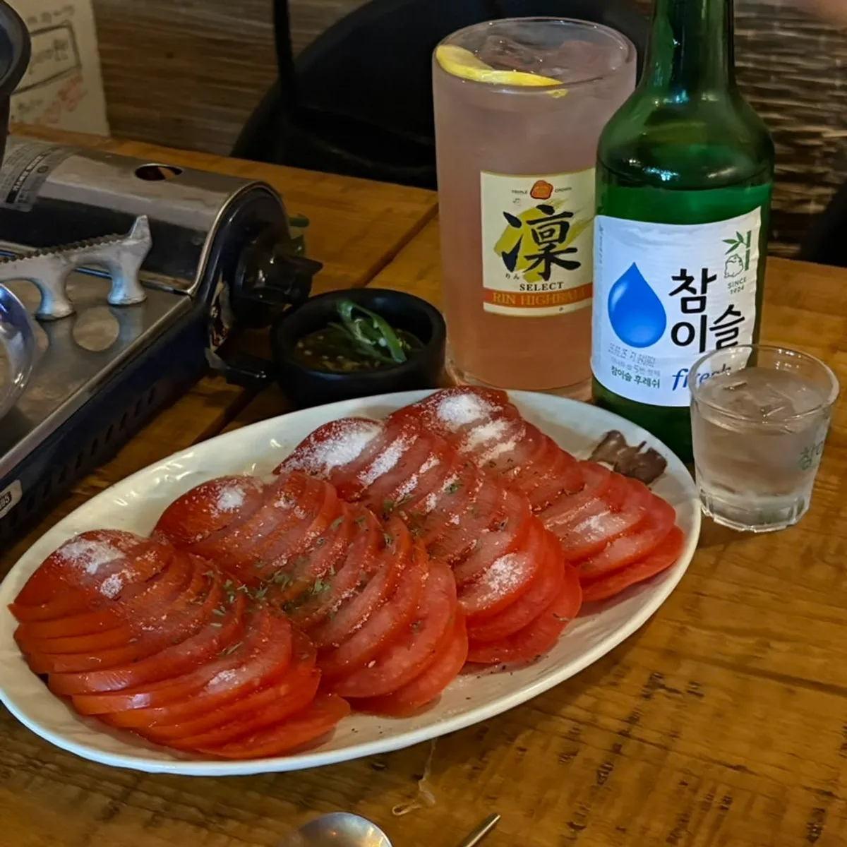 Table with sugar tomato, soju, and a peach highball