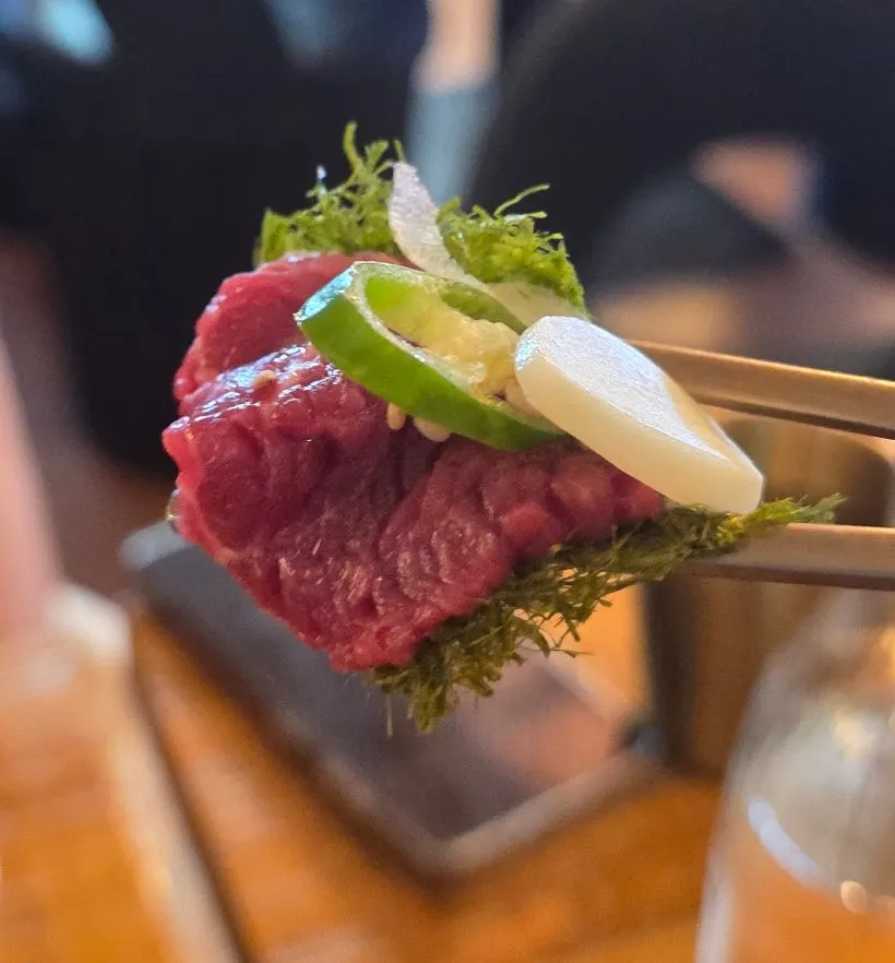 A piece of Korean beef yuk sashimi