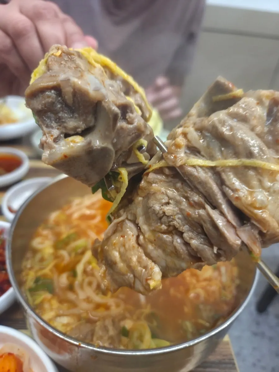 Spicy bone kalguksu broth topped with chili paste