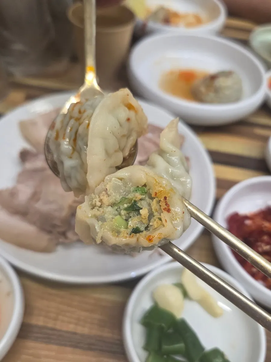 A bowl of spicy bone kalguksu enjoyed with day drinks