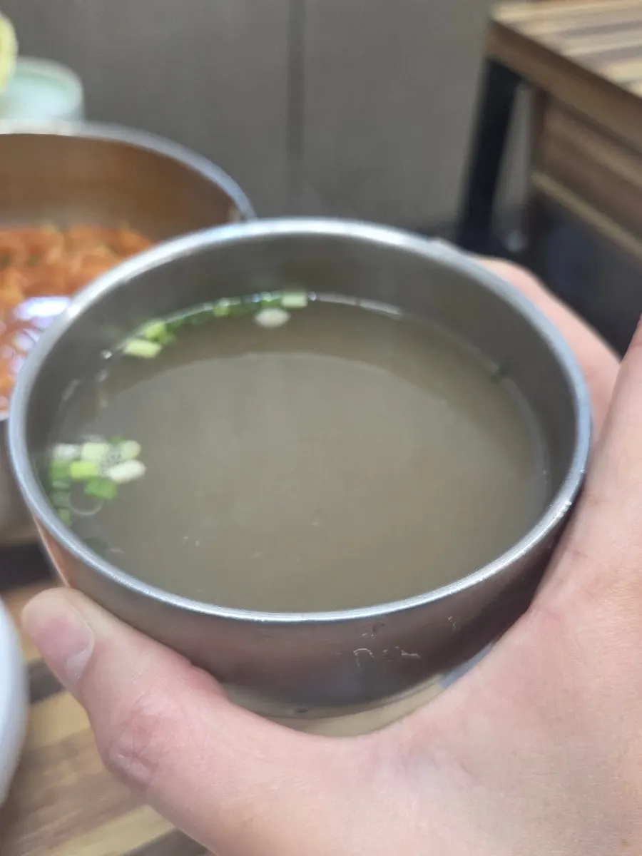 Bossam meat dipped in the complimentary broth