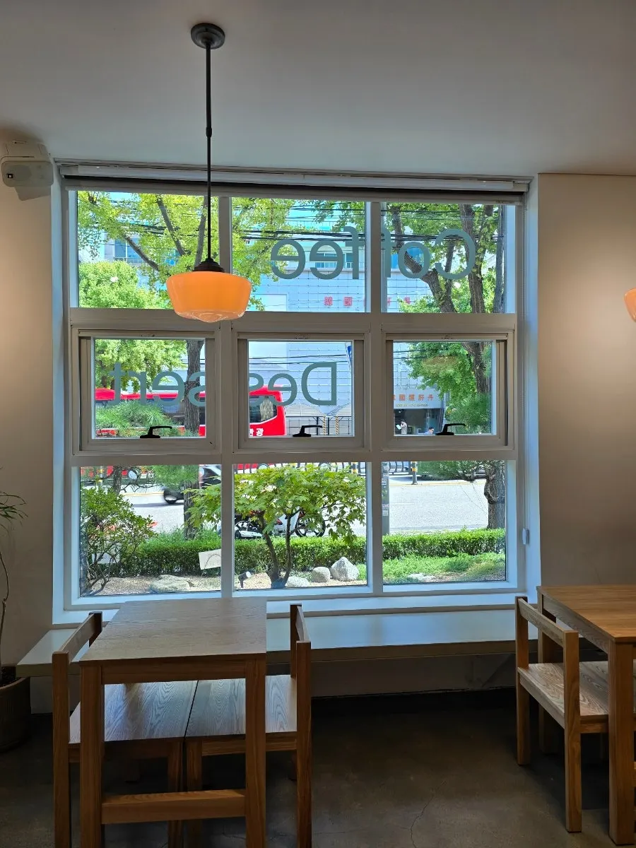 Café with wooden tables and white walls