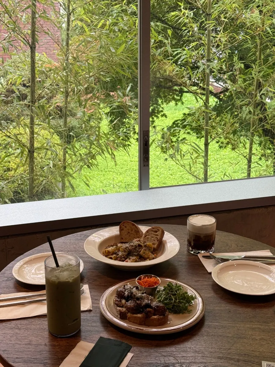Brunch spread beneath the floor-to-ceiling green view