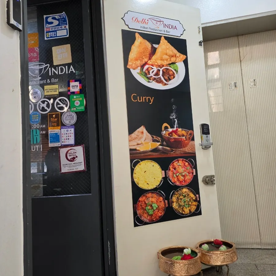 Indian cuisine sign and second-floor entrance