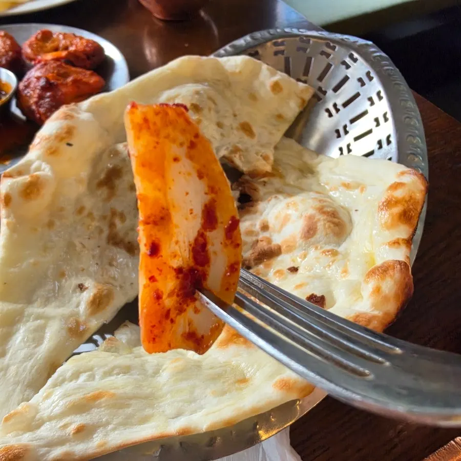 Onion kimchi served with butter chicken curry