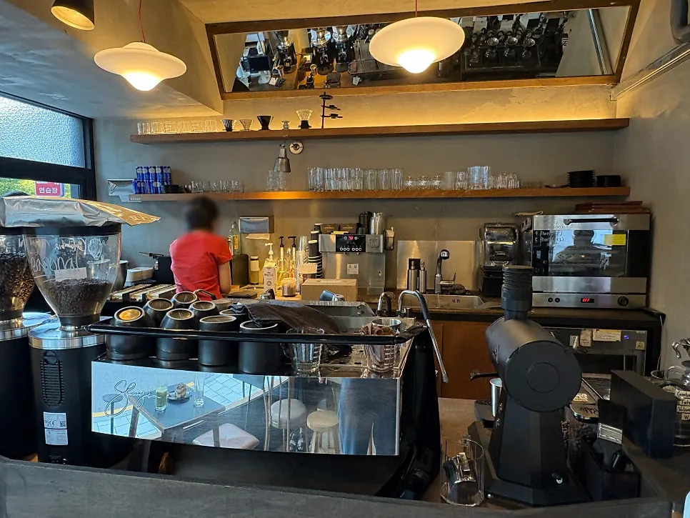 Various beans and brewing equipment lined up on the bar