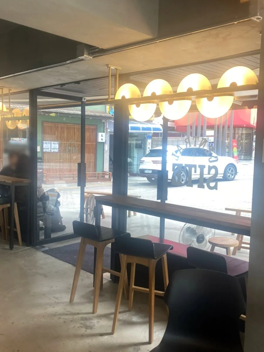 Café interior with coffee-themed decor and menu display