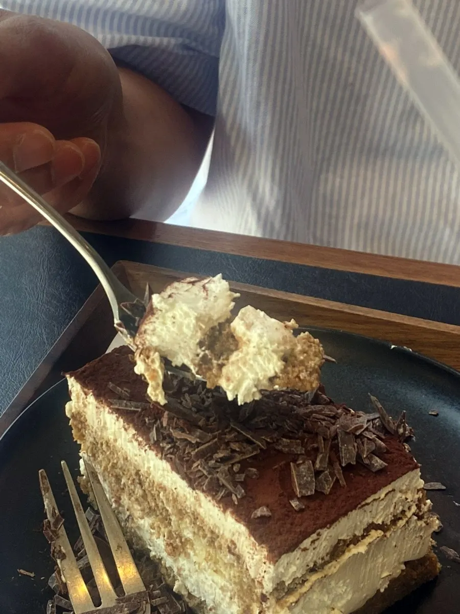 A forkful showing the moist tiramisu layers