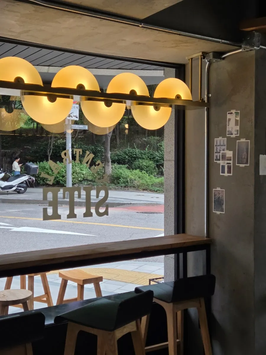 Interior of the café with floor-to-ceiling window seats visible
