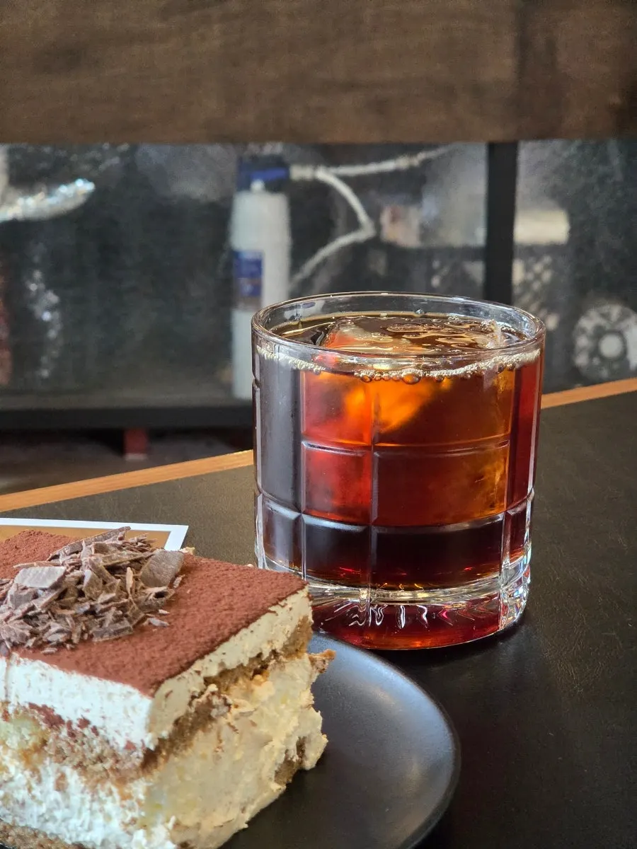 Iced drip coffee cup with one large ice cube