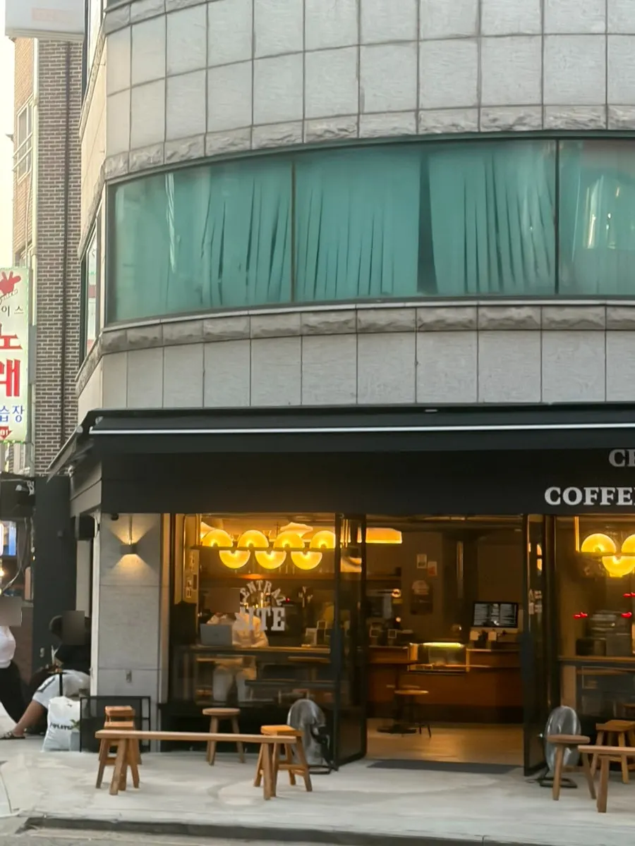 Central Site Hapjeong café front lit up in the evening