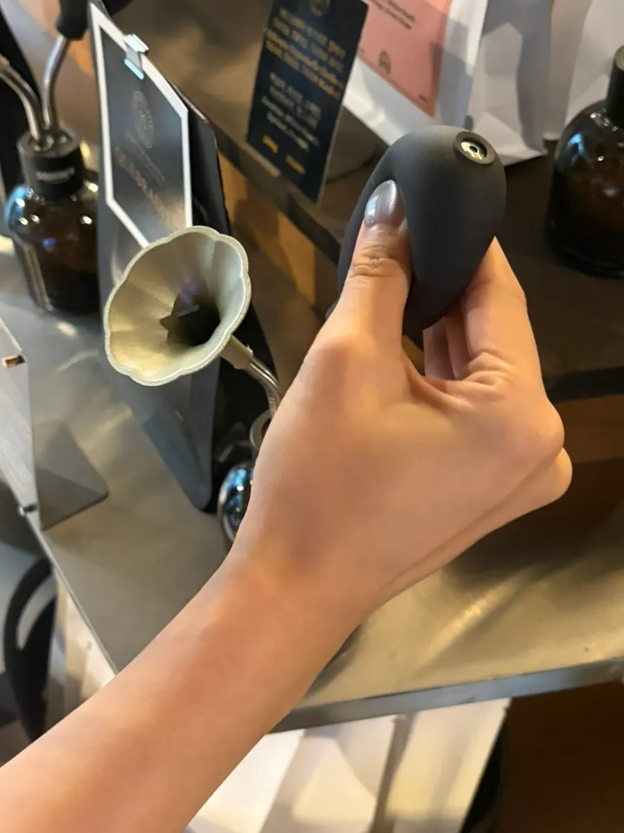 Pressing a pump to smell the bean aroma