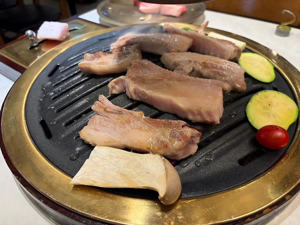 Bone pork belly and pork neck cooking over charcoal