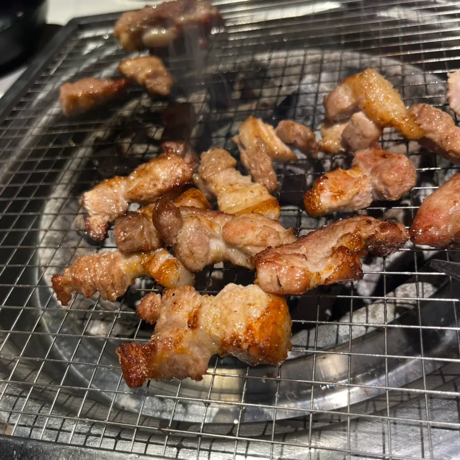 Fresh ribs cooking over charcoal