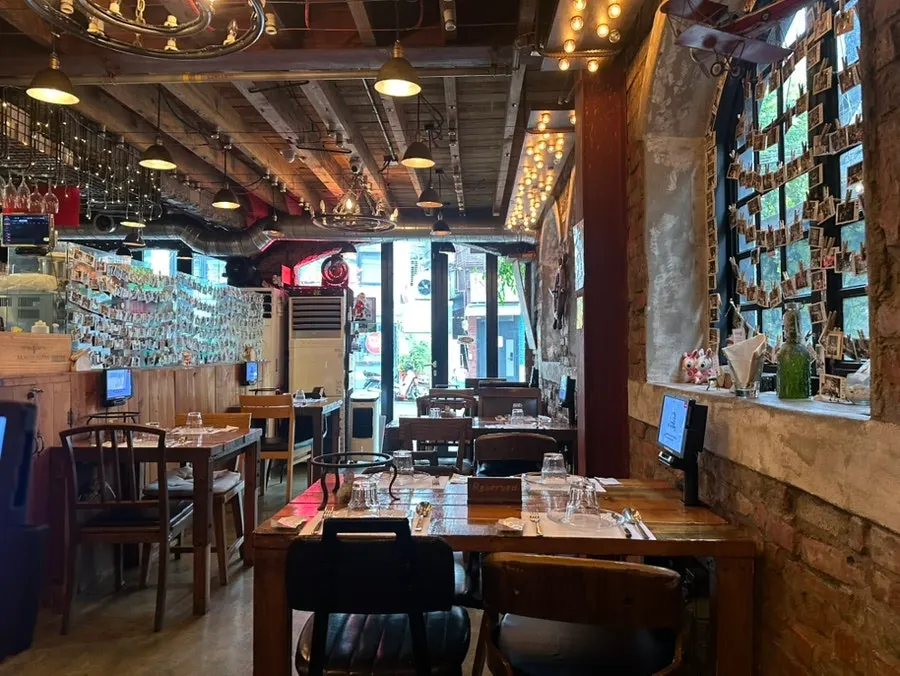 Interior of Hongdae Hwadeok Pizza with wood decor and cozy lighting