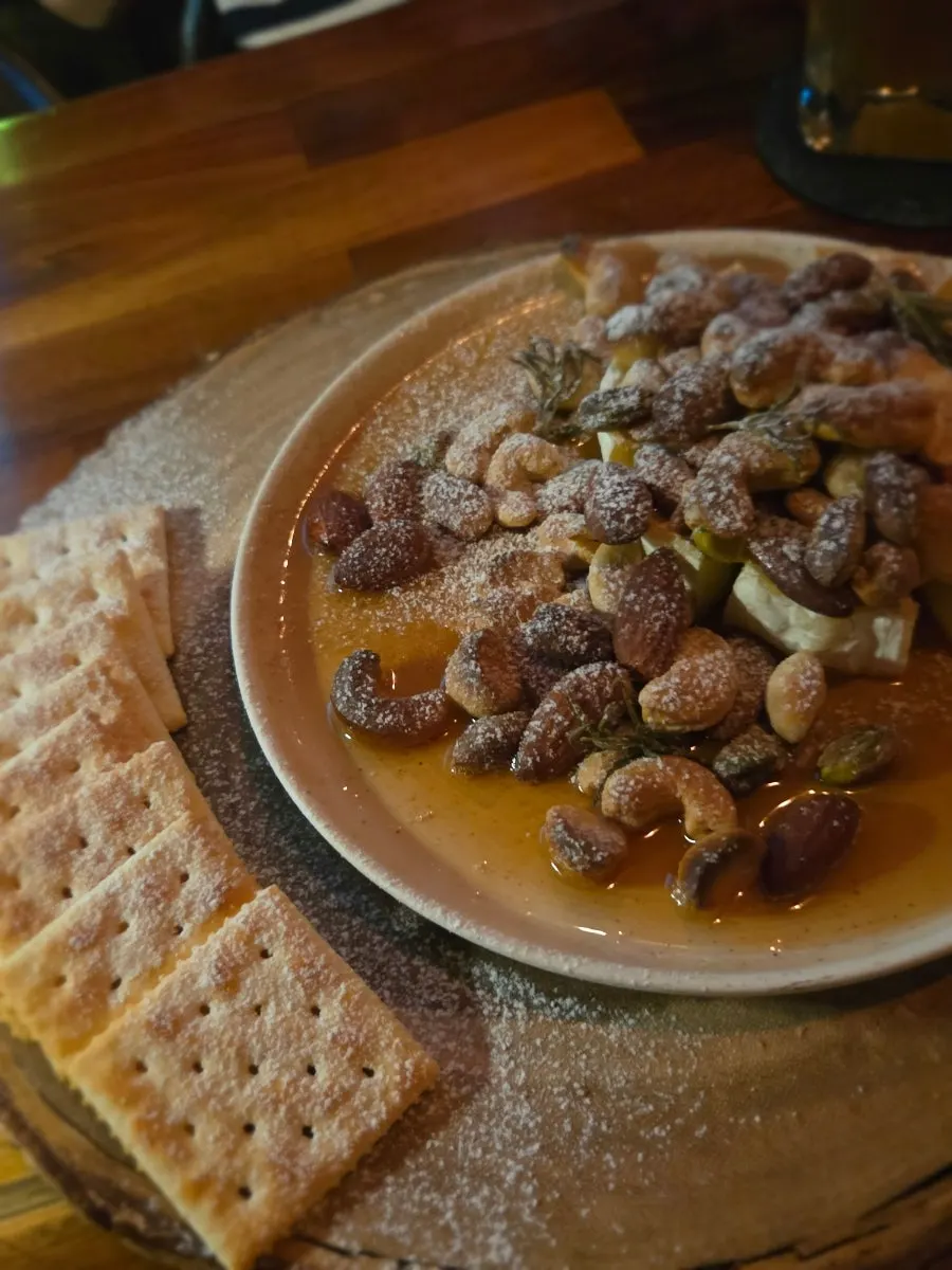 Plate of grilled camembert cheese served with crackers