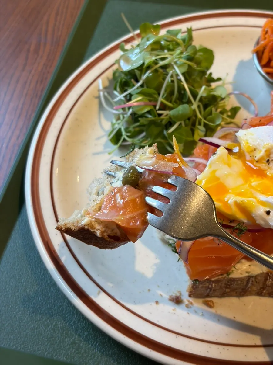 Salmon open sandwich with the poached egg broken open