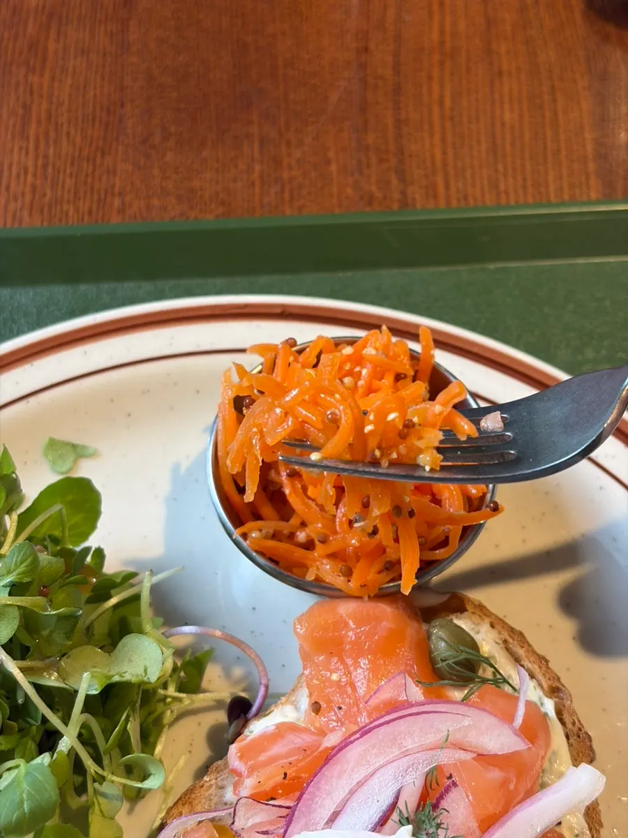 Benedict served with baby greens and carrot rapé