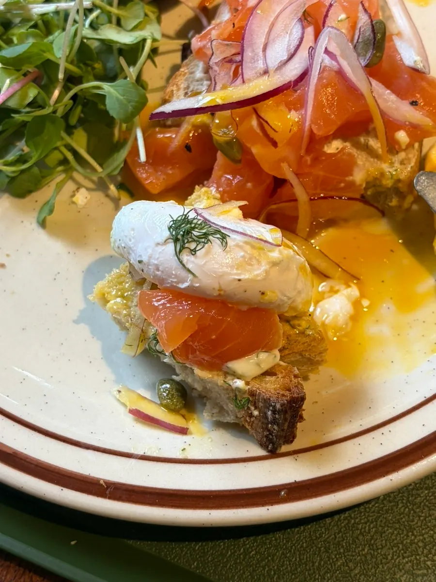 Sandwich cut into bite-sized pieces with poached egg on top