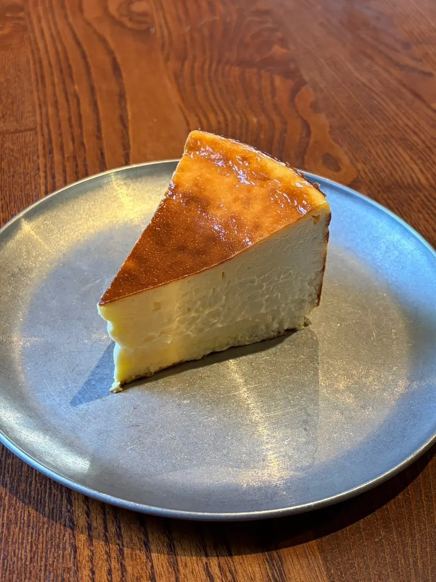 A slice of handmade Mom's Basque cheesecake