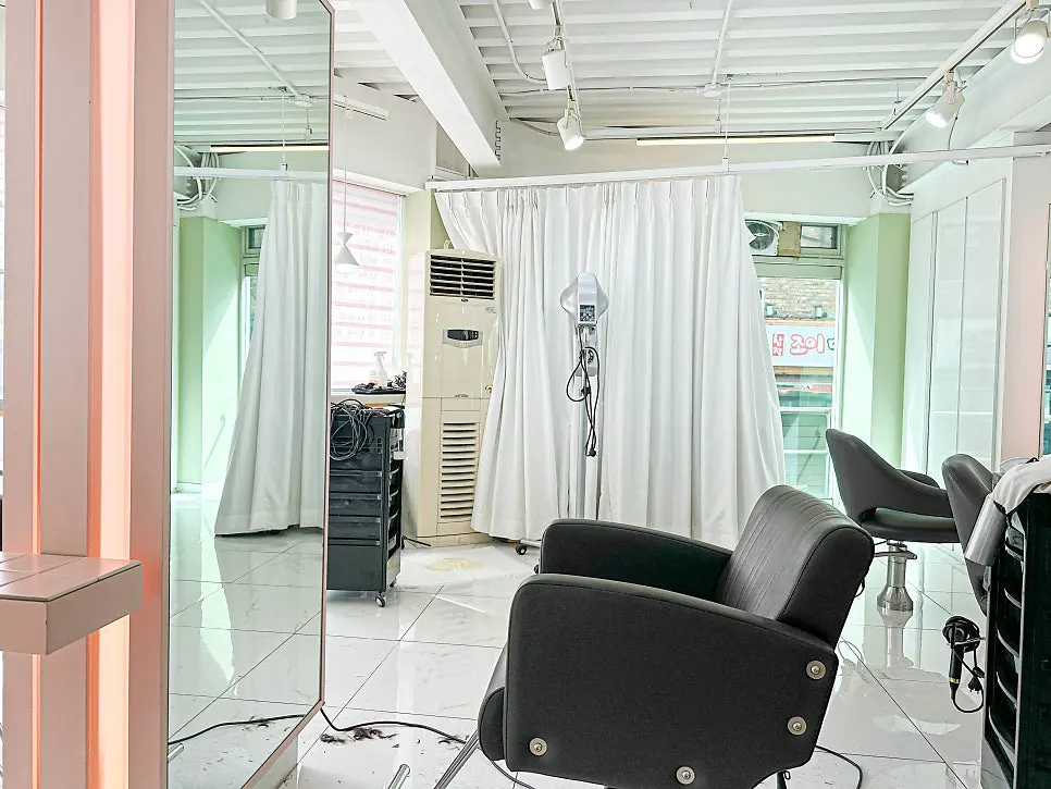 Salon seating and mirror area at Pieum Hair