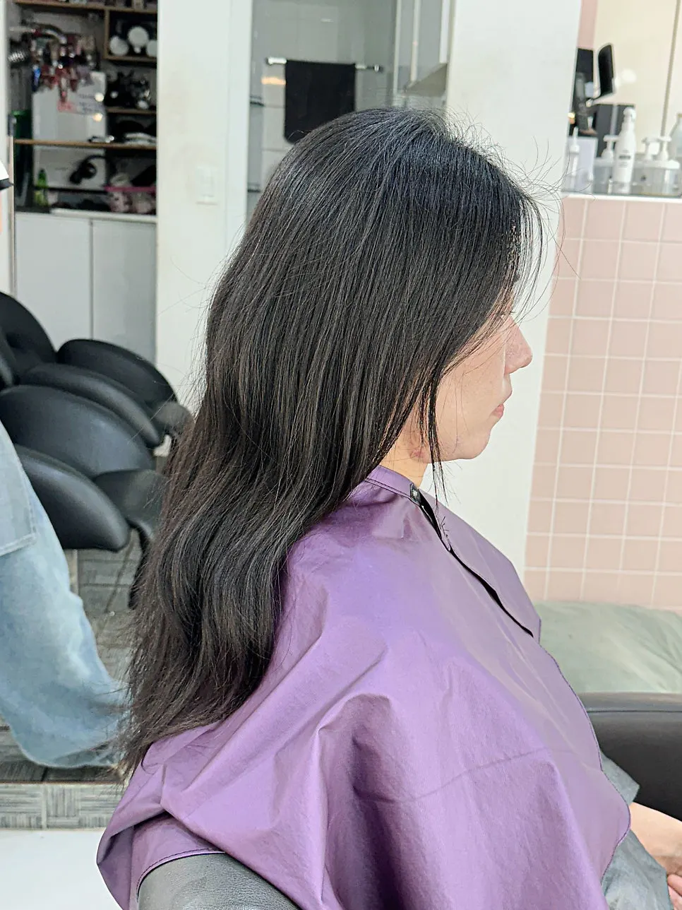 Side view of long hair during the perm process