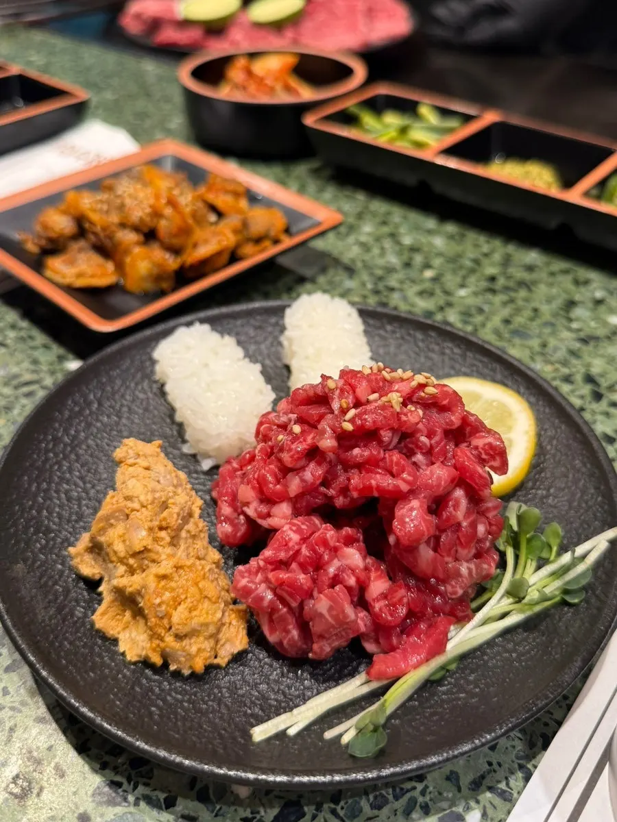 Basic side dishes including cockle salad and yukhoe
