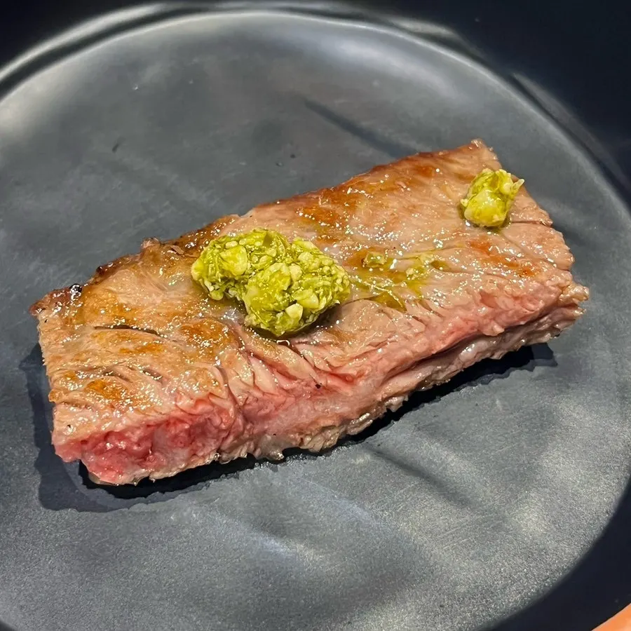 Creamy basil sauce served alongside the sirloin