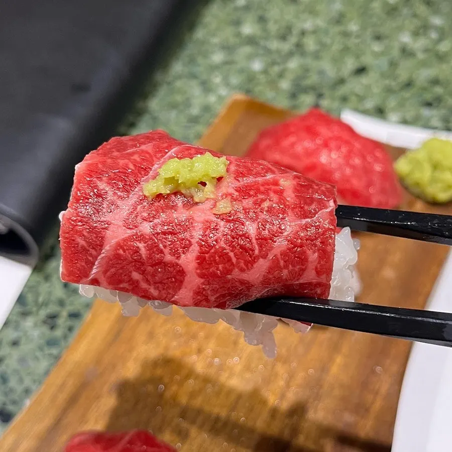 Beef sashimi served over vinegared rice