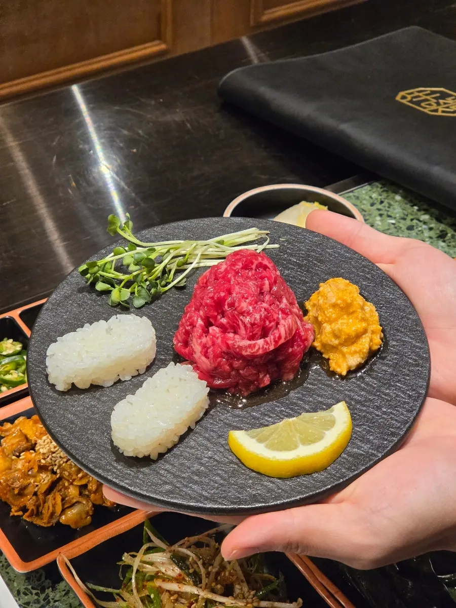 Service dishes of cockle salad, yukhoe, and ankimo