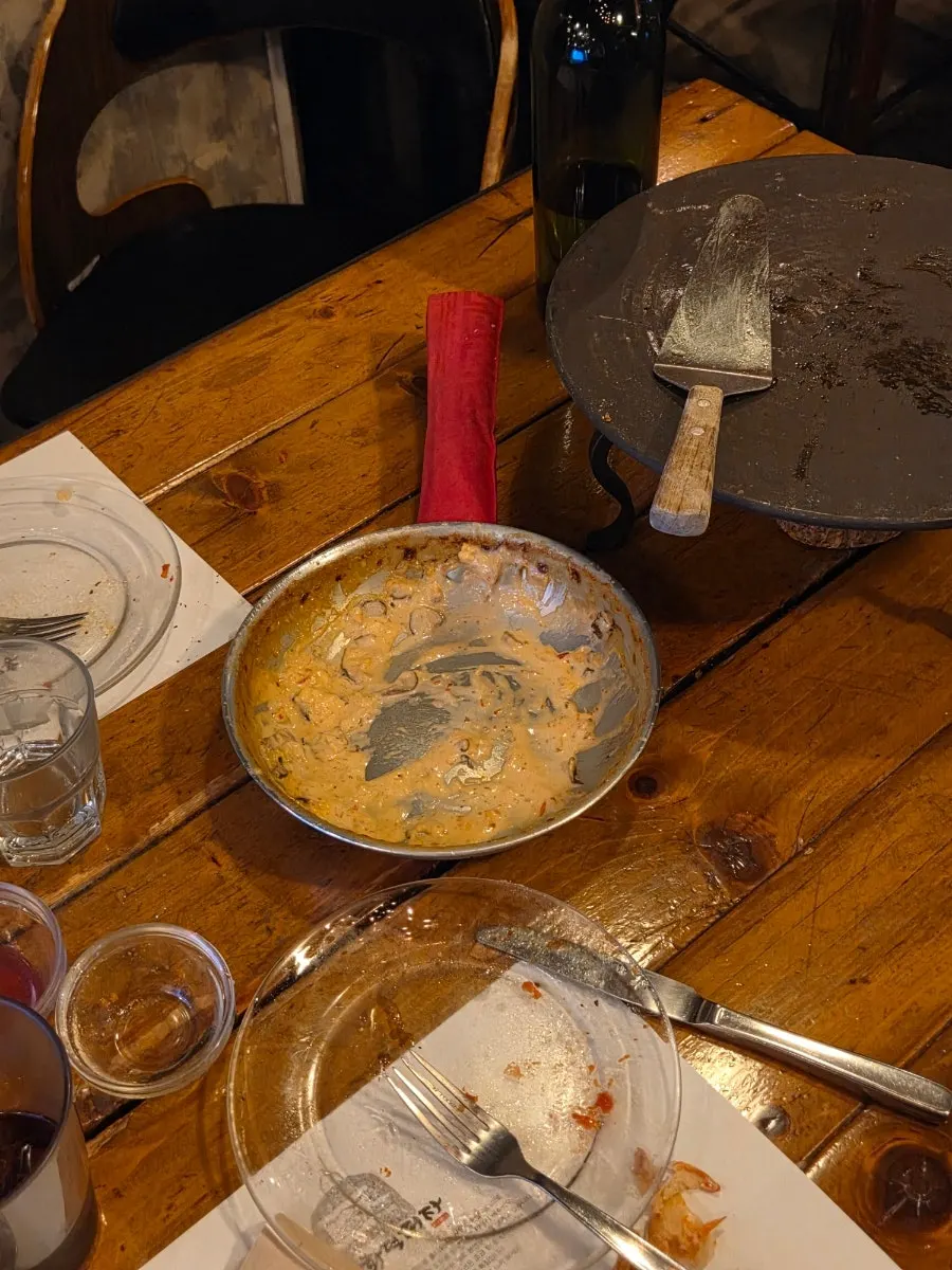 Table with pizza and penne together