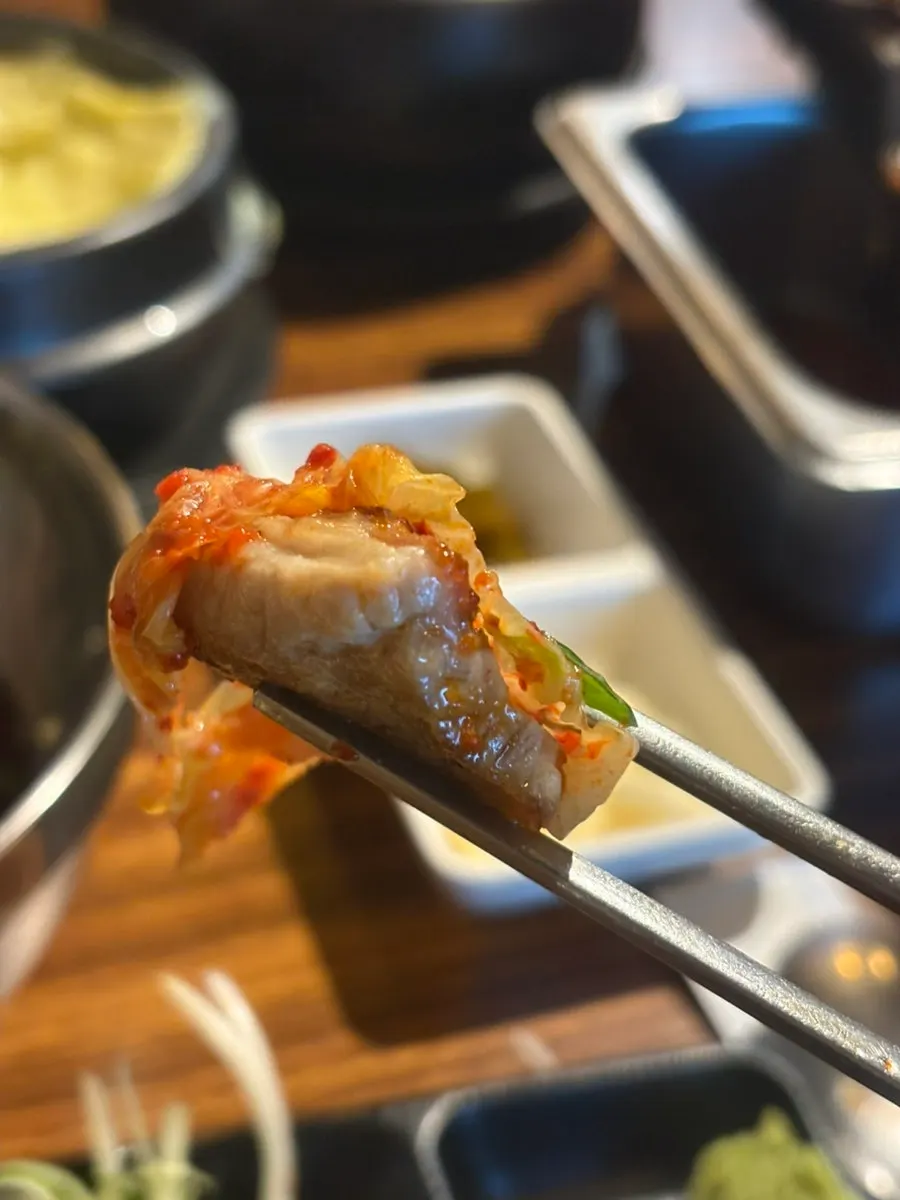 Pork belly wrapped in a lettuce leaf