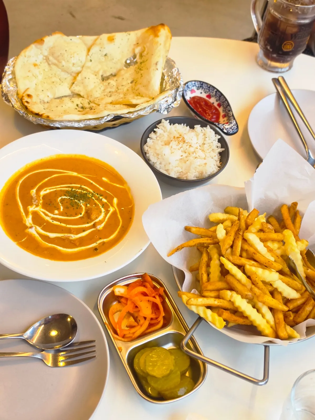 Chicken makhani curry and naan on the table