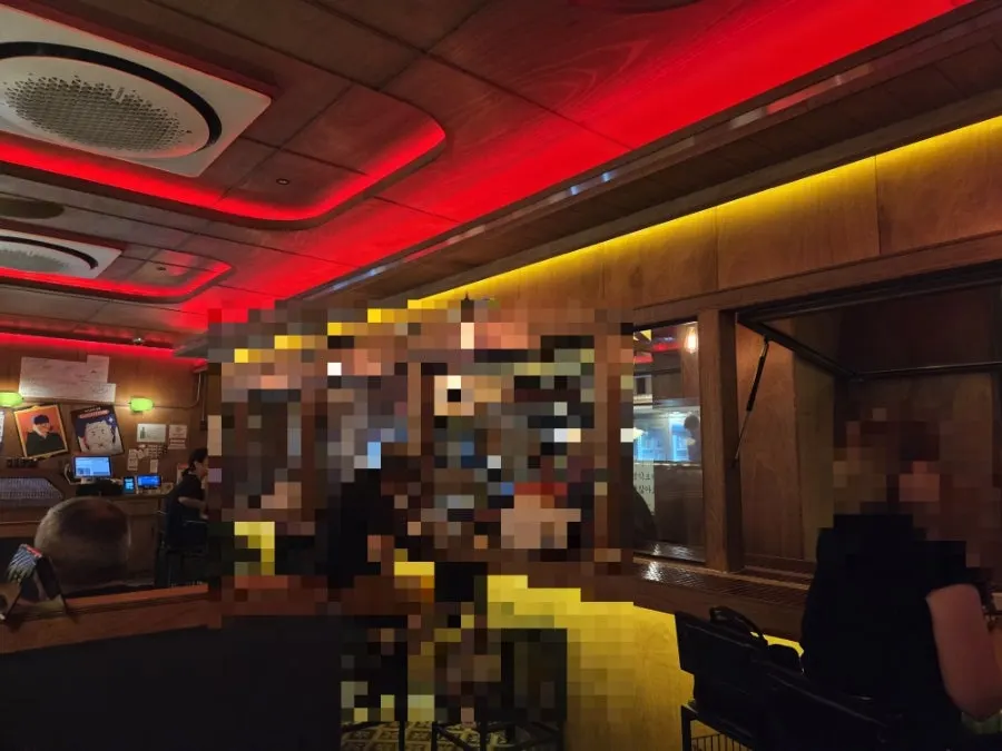 Interior with wooden bar tables and orange lighting