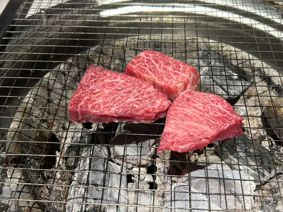Hanwoo 1++ sirloin cap cooking on the grill