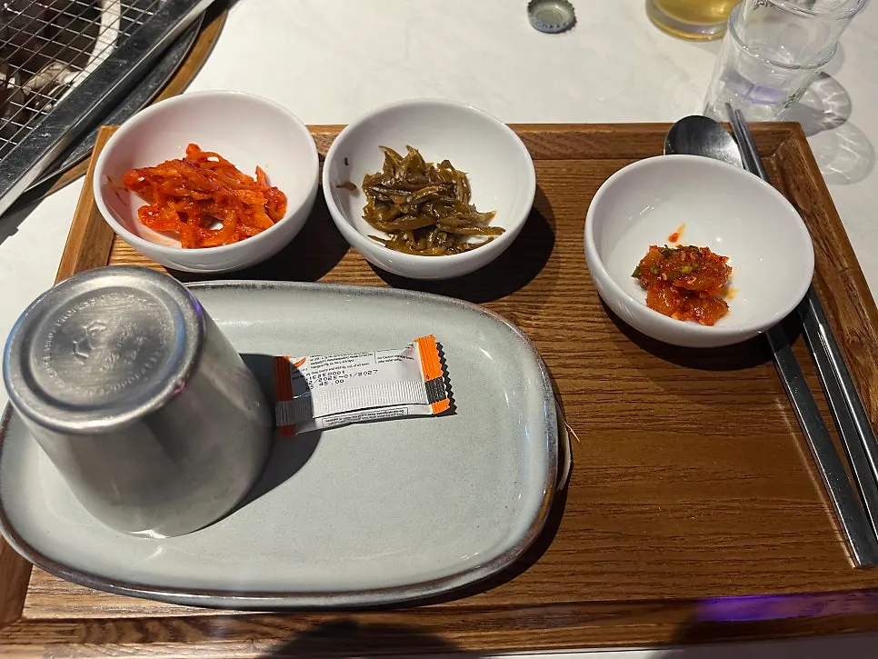 Individual side dishes: radish salad, pickled chili strips, salted squid