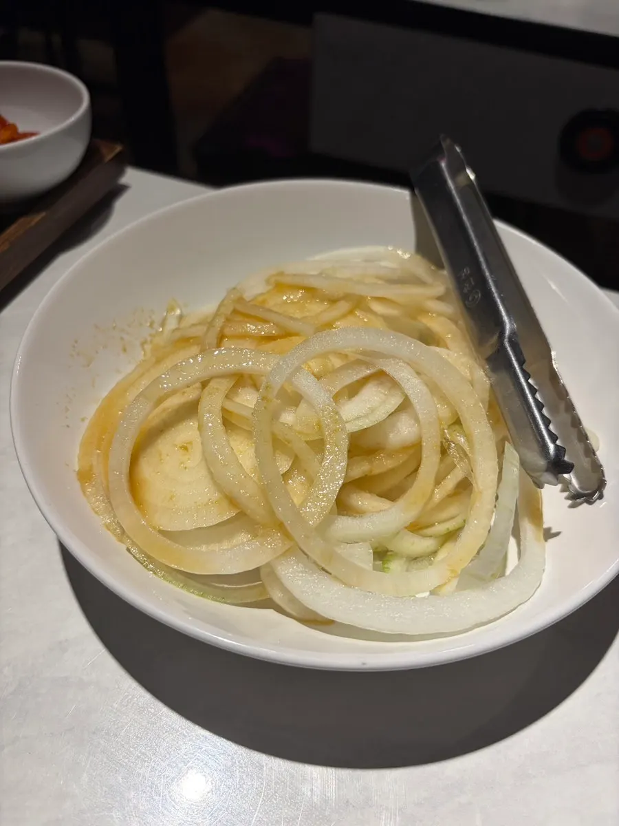 Side dishes including radish salad, pickles, and pickled onions