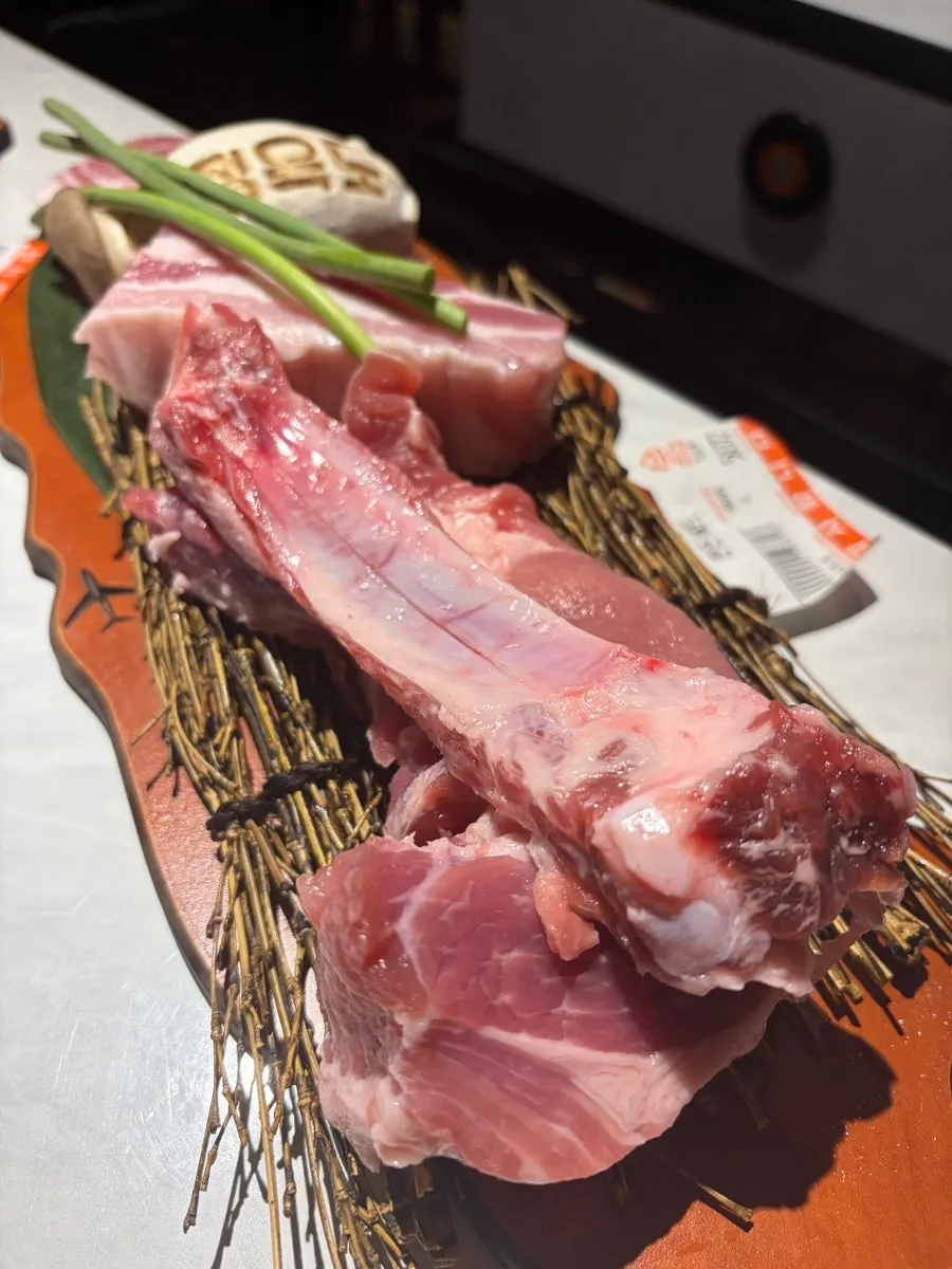 Raw meat plated on straw and branch decorations