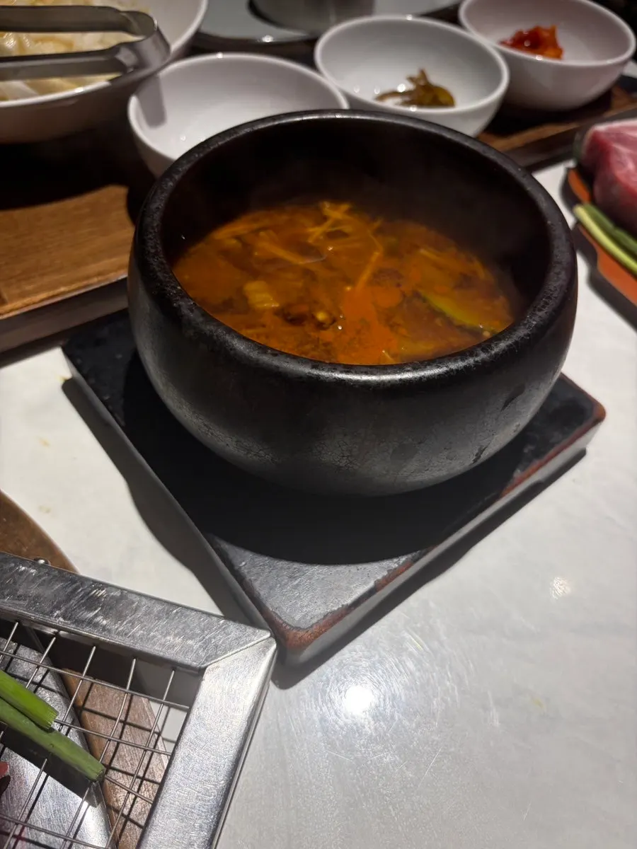 Grilled meat served alongside pickled onions