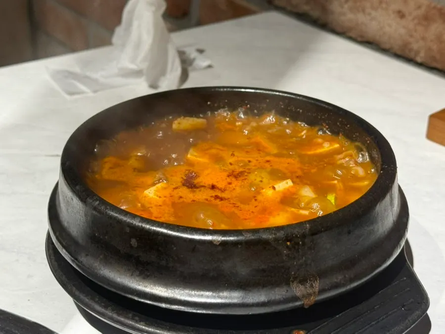 Fully grilled cuts of meat alongside side dishes