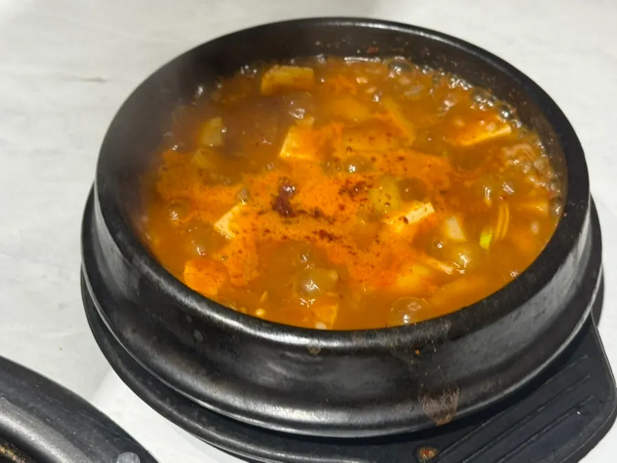 A bite of meat paired with melt anchovy stew